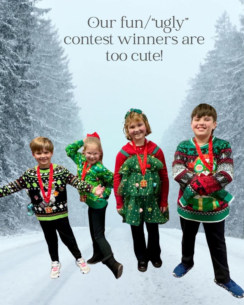 Four students in Christmas sweaters