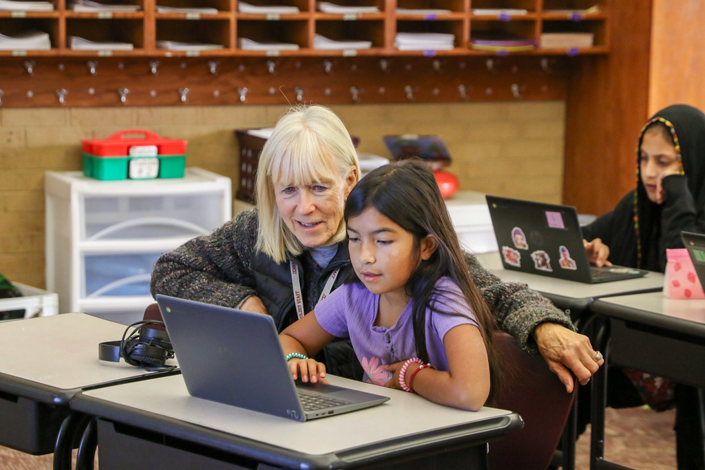 student getting assistance from her teacher
