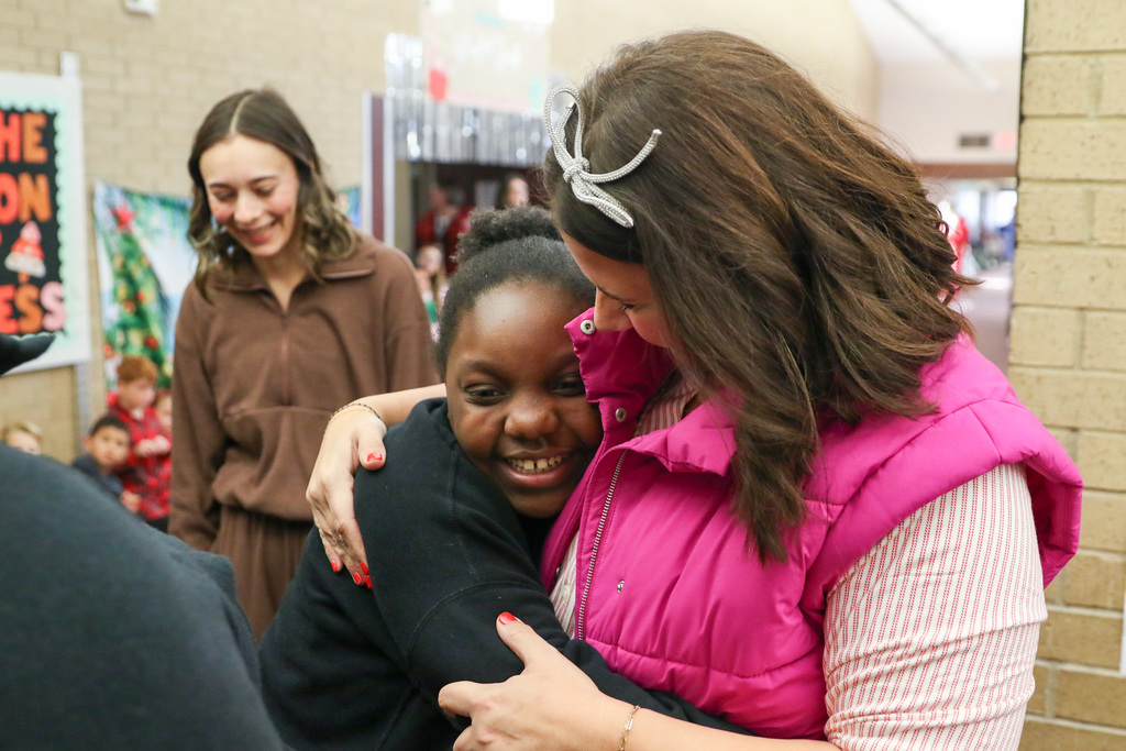 student being hugged by principal