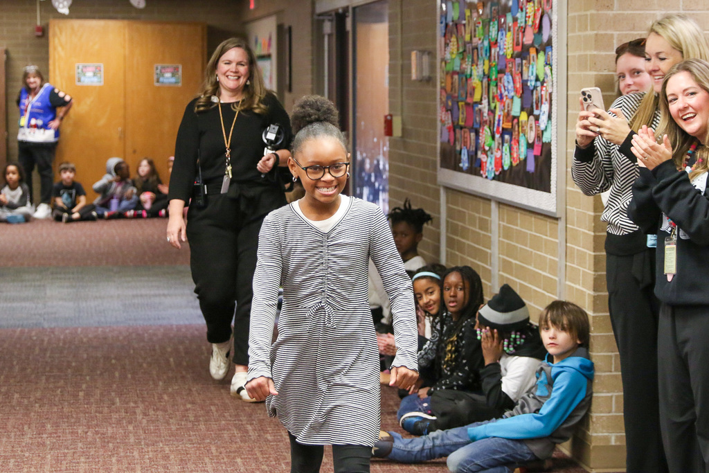 student walking down smiling to get her bike