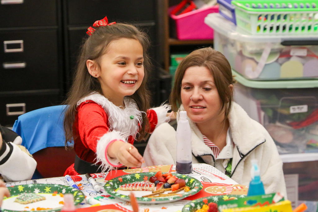 girl smiling with her mom down beside her