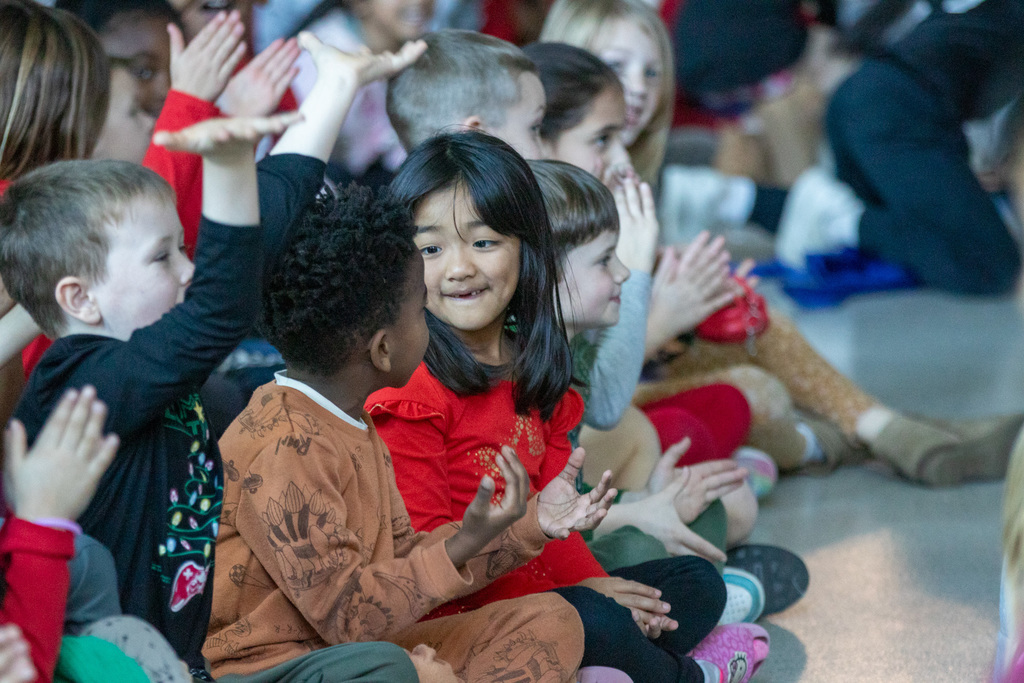 student smiling and clapping
