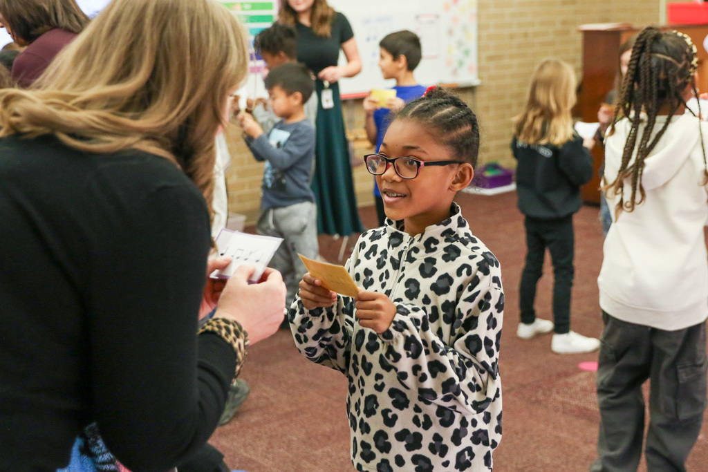 student playing a game in music trying to match her music notes to someone else's
