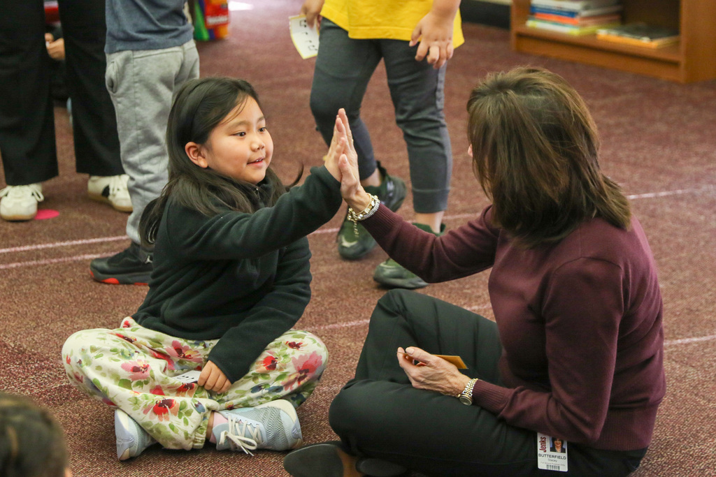 dr. butterfield and a student high fiving