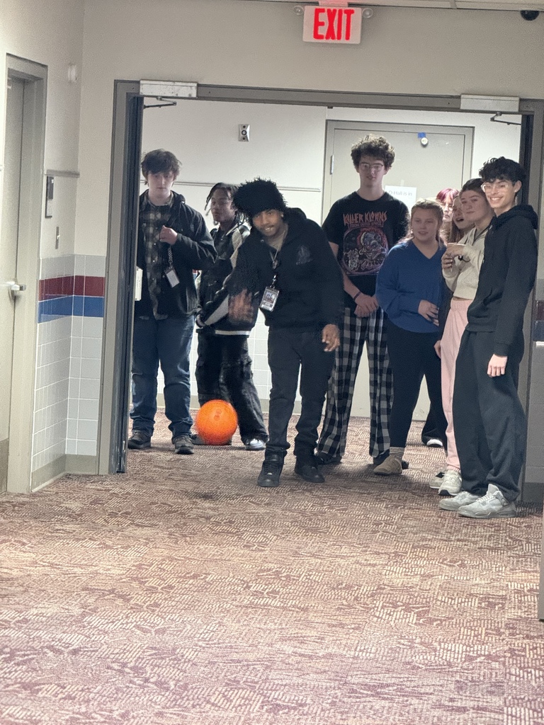a group of students watching bowling