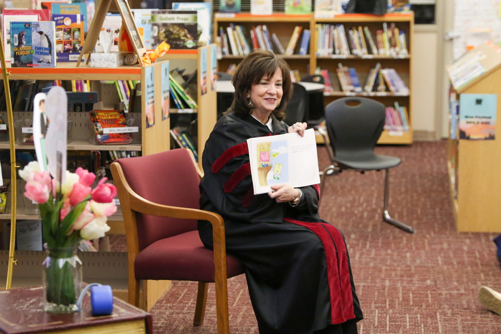 dr. butterfield smiling and showing the pages