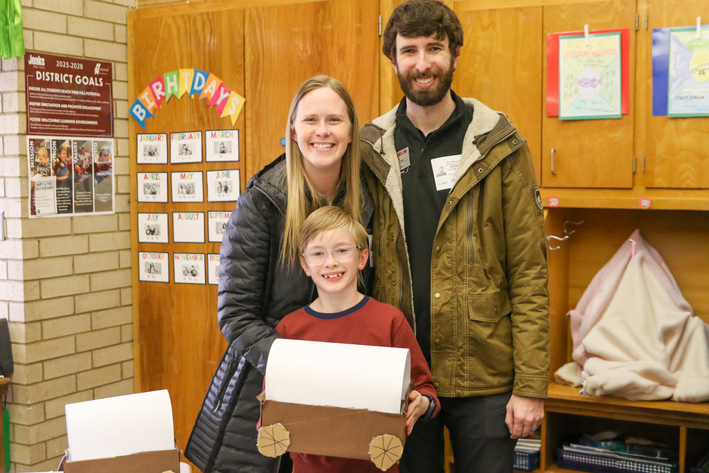 family posing with their son for his wago