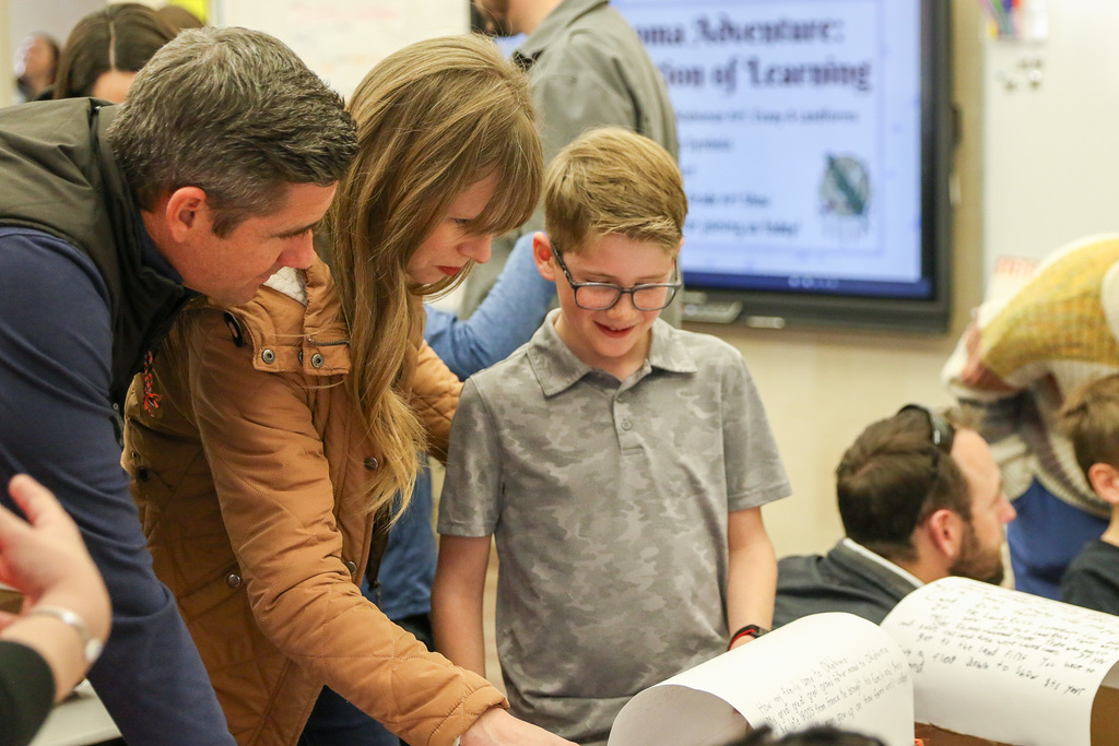 boy showing his parents his wagon