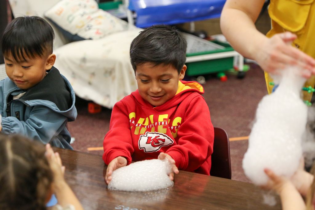 boy playing with bubbles on the table