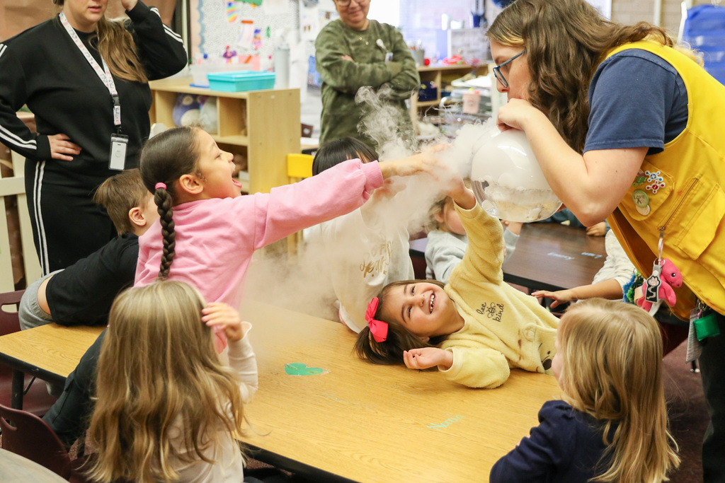 Discovery Lab employee creating cloud bubbles for students to touch