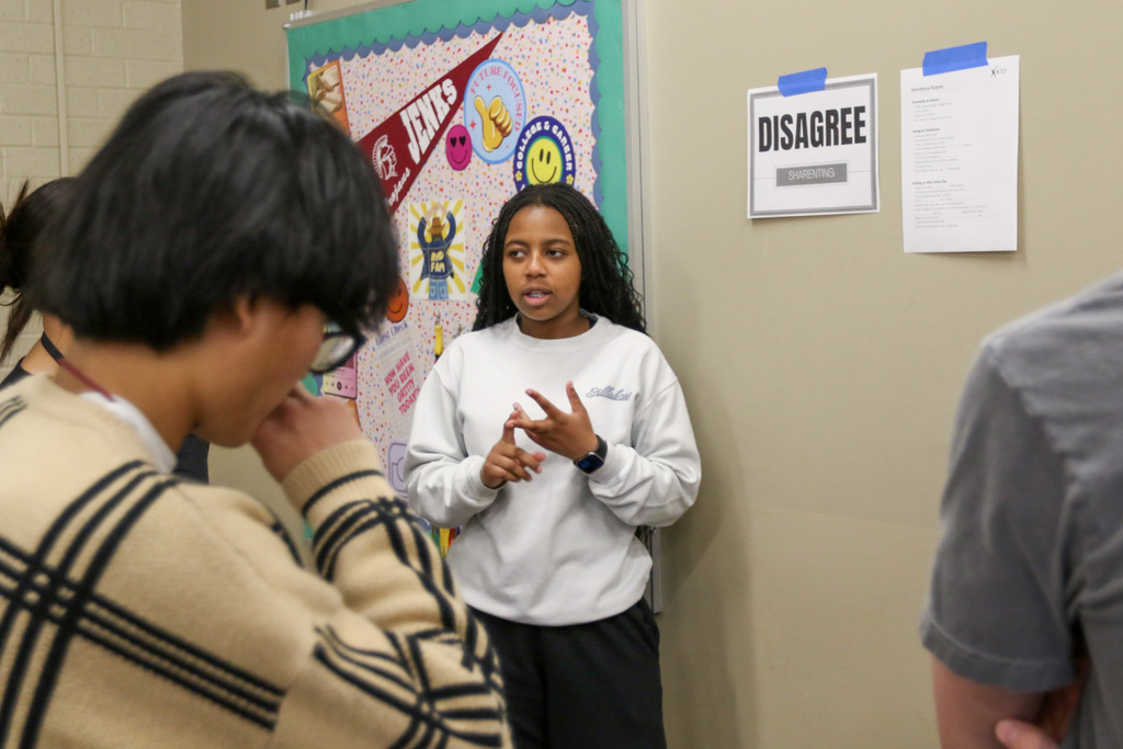 students playing 4 corners and using sentence stems to discuss their opinion on a topic