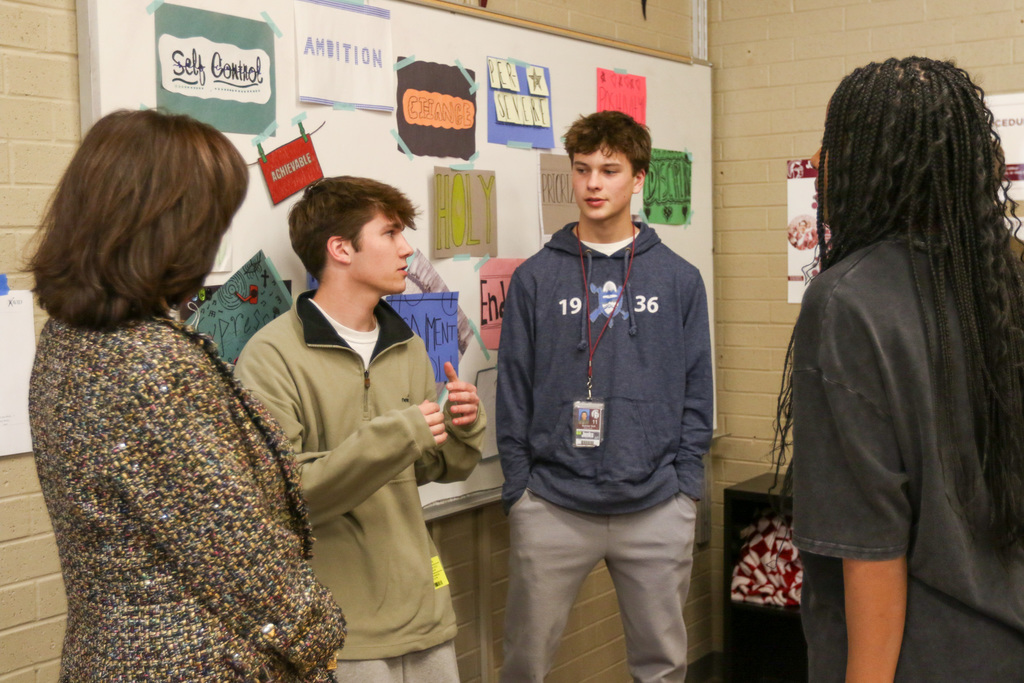 dr. butterfield with students as they discuss