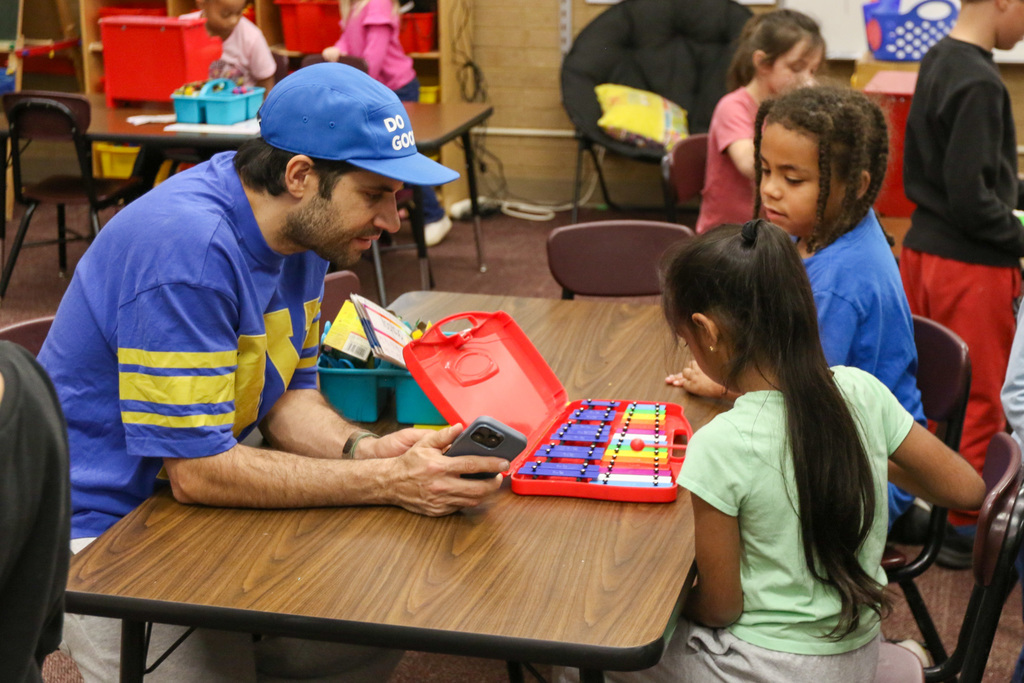 hot toast listening to students play xylophone