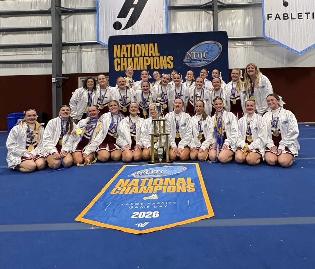Jenks Varsity Pom team in white jackets 