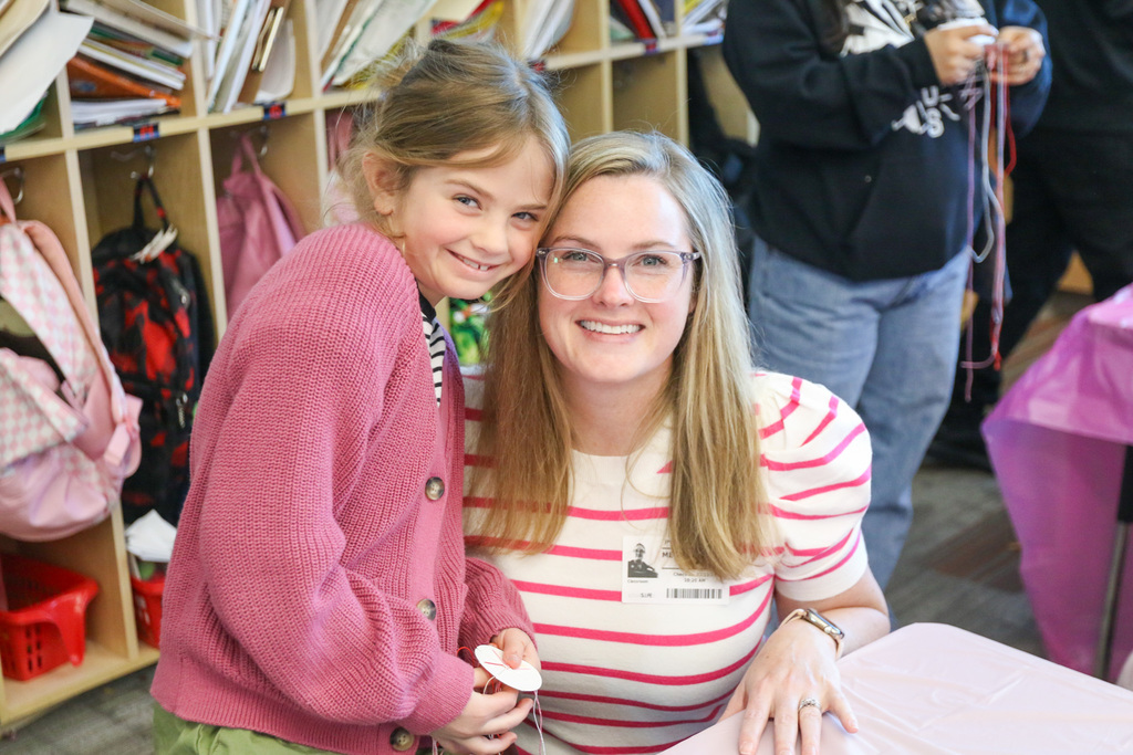 Mom and daughter posing for a photo together