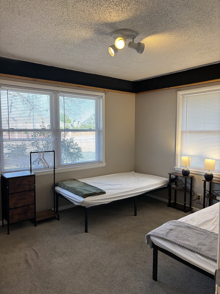 photo of empty bedroom with two beds assembled by Jenks High School students