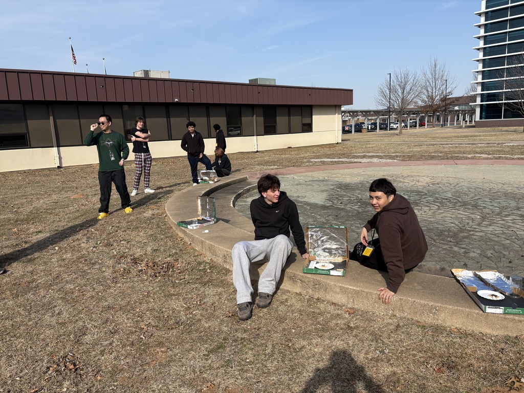 shot showing students with their solar ovens