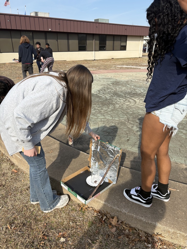 students setting up solar ovens
