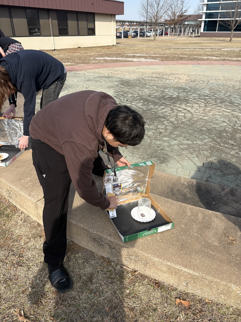 a student setting up a solar oven
