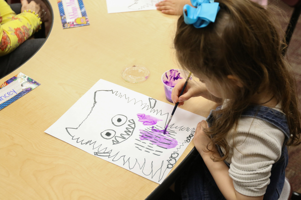 a student panting a lovely monster