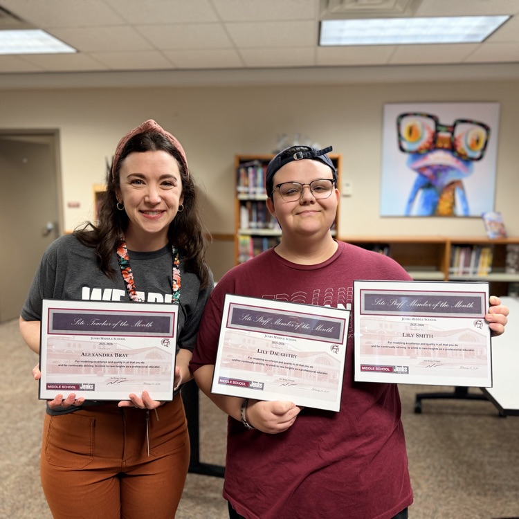 staff members of the month holding certificates 