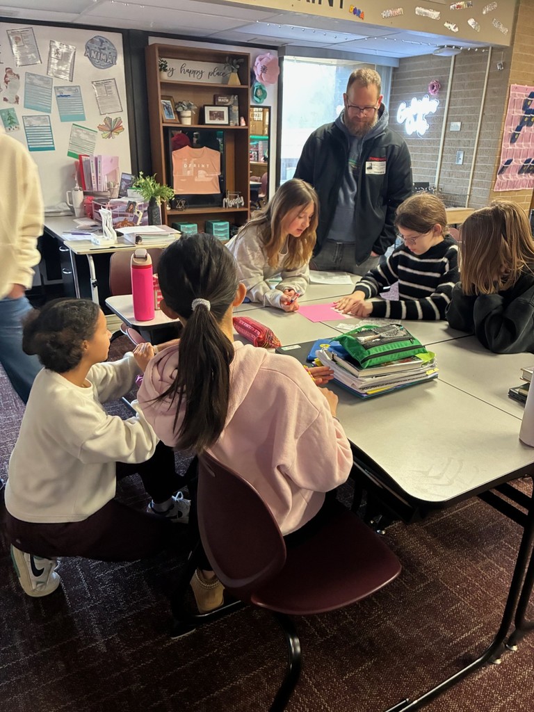 students in classroom doing a Dynamic Dads activity with a guest dad