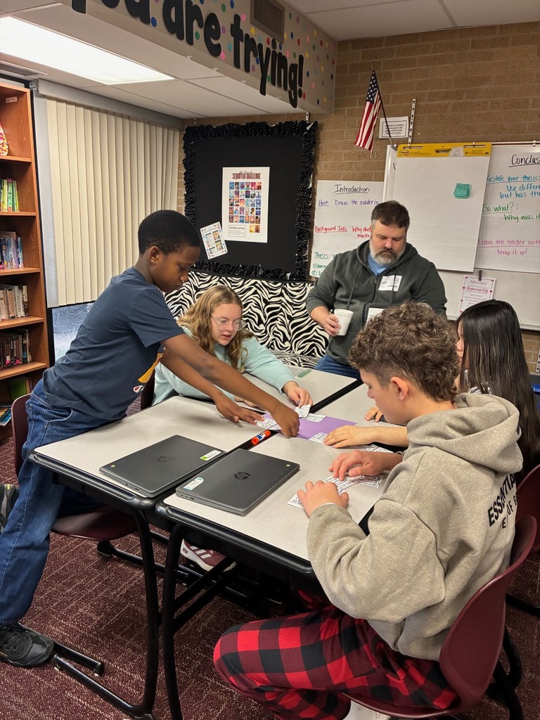 students in classroom doing a Dynamic Dads activity with a guest dad
