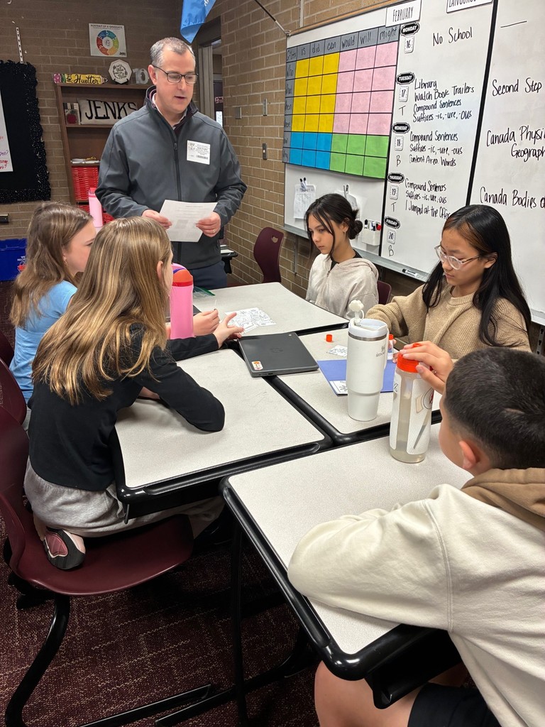students in classroom doing a Dynamic Dads activity with a guest dad