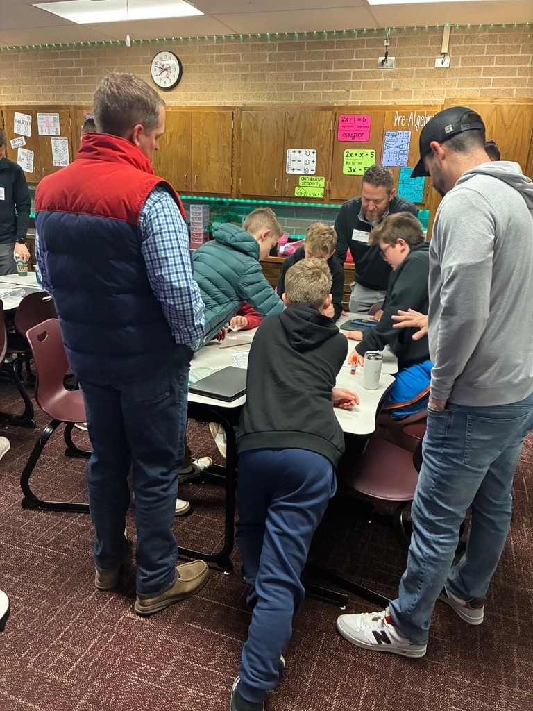 students in classroom doing a Dynamic Dads activity with a guest dad