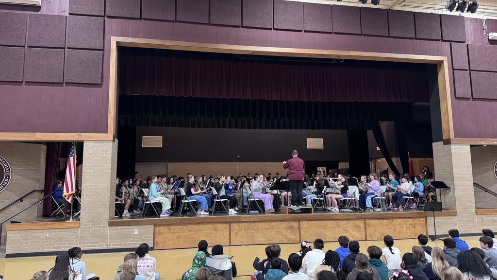 6th grade band students on stage performing for 5th grade students