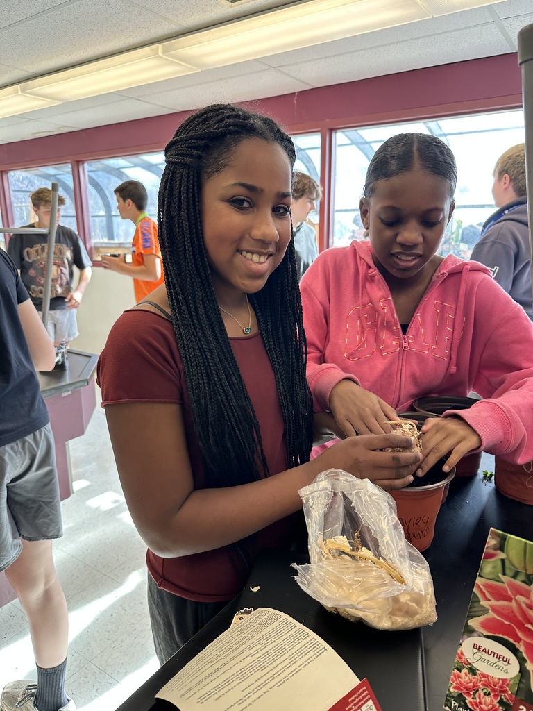 two girls planting seeds