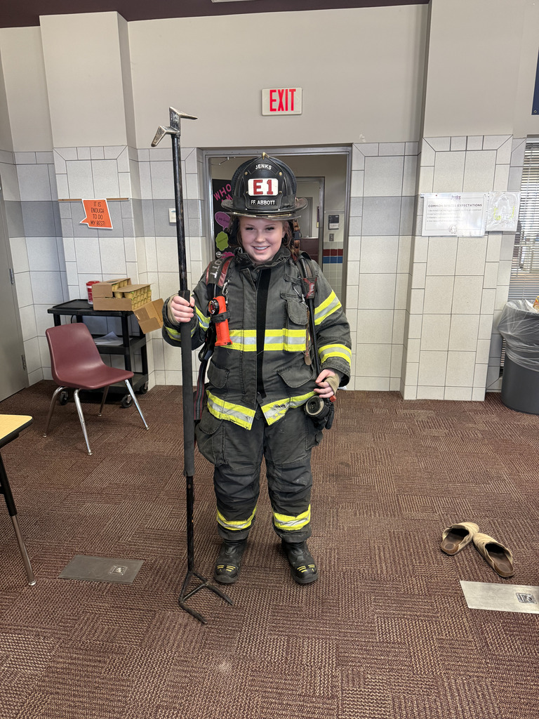 A student wearing full firefighter gear