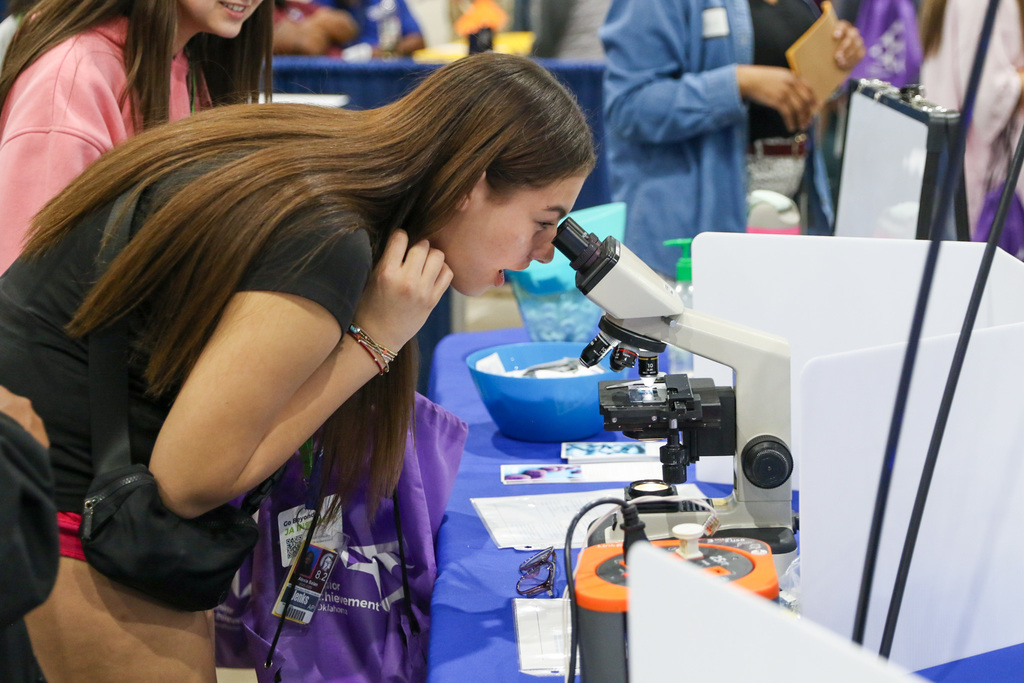 student looking into a microscope