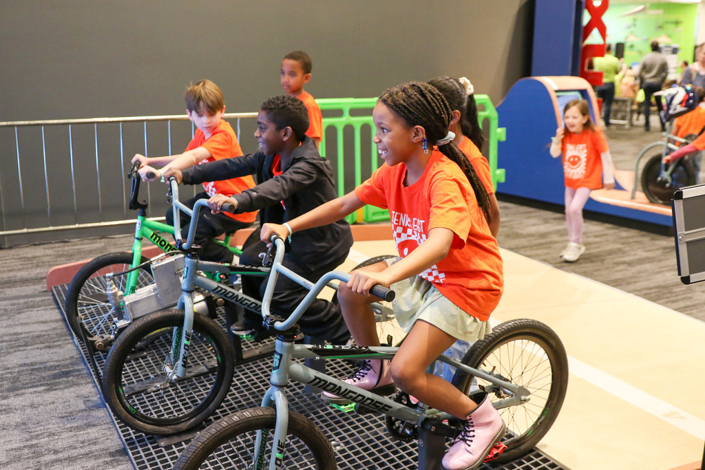 students on bikes playing a racing game