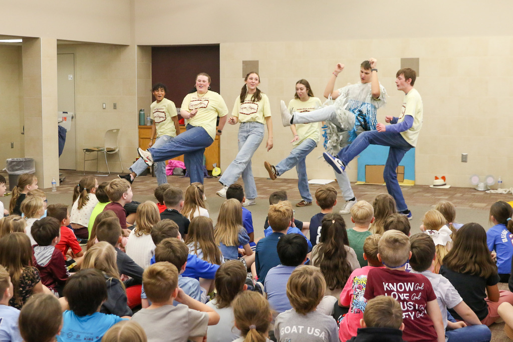Six high schoolers dancing a scene from "Stories From and Elementary Classroom" to Jenks Southeast students.