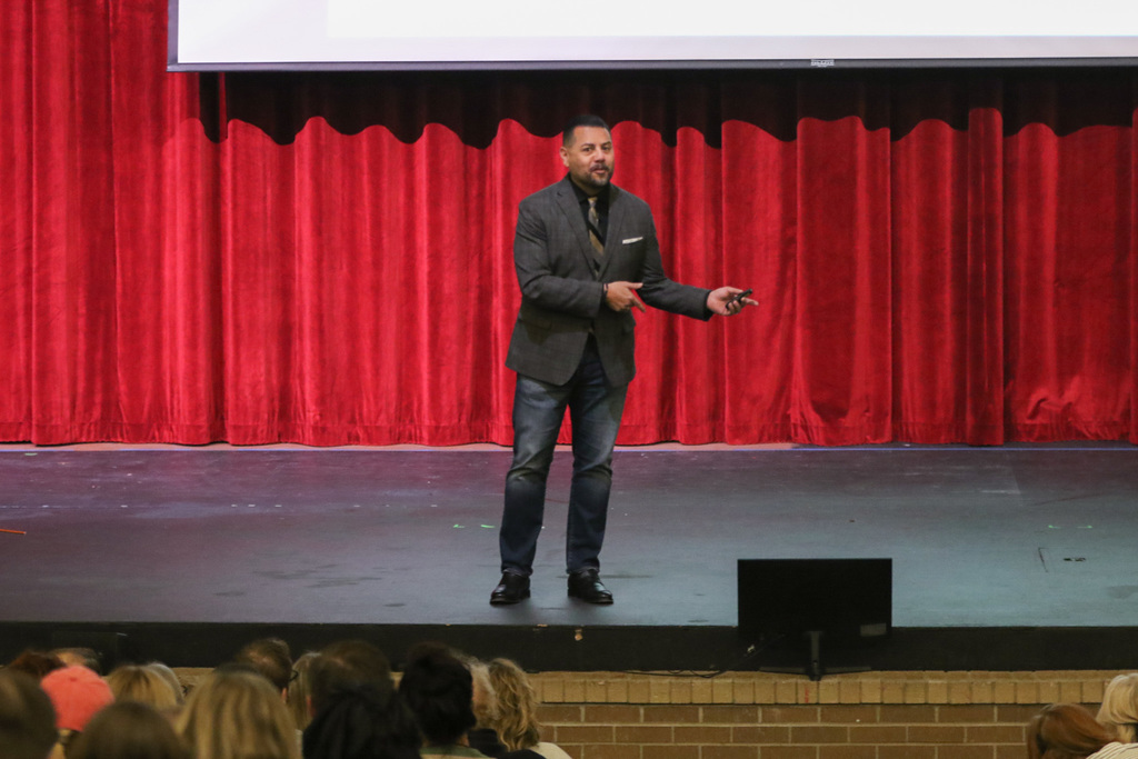 dr. cruz on stage talking to our staff