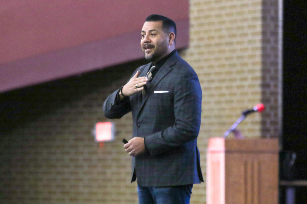 dr. cruz on stage speaking to our staff in the crowd