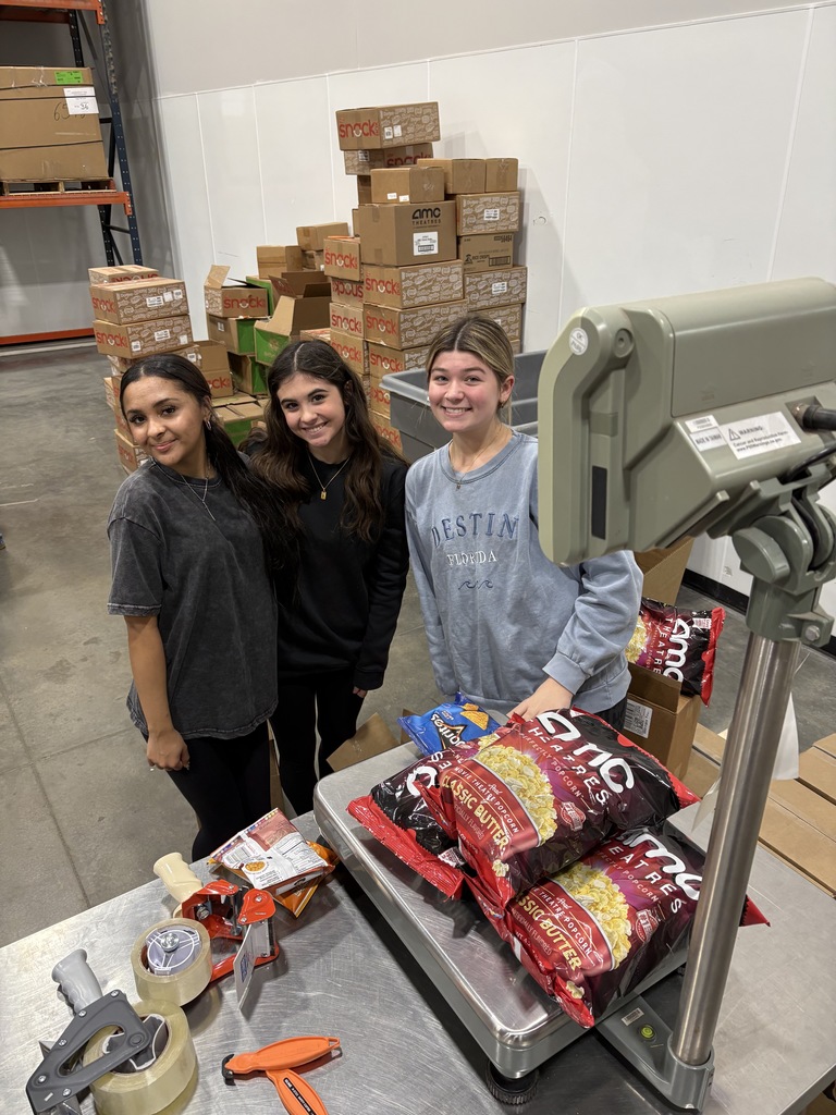 three students weighing popcorn