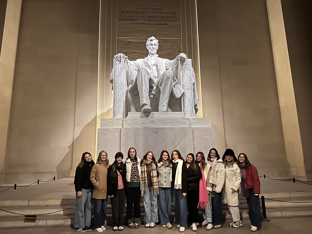 Group of Jenks High School students in front of statue at Lincoln Memorial in Washington D.C.