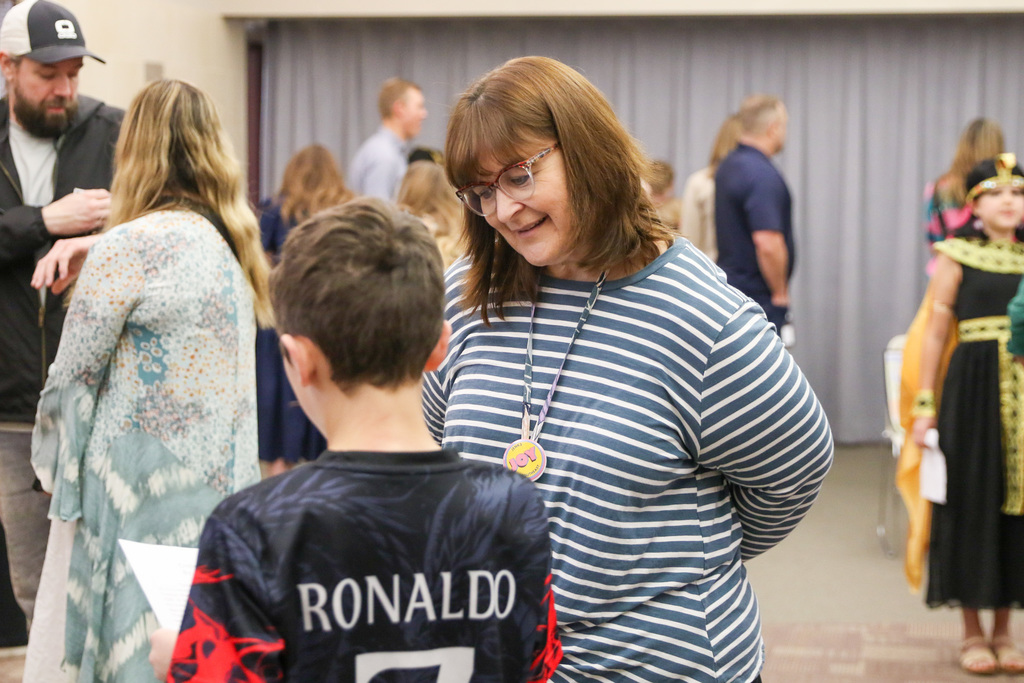 Principal Dina McClellan listening to a student present.
