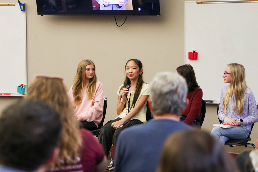 Girl answering a question during the Q&A using a microphone.