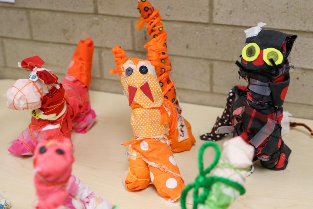 A Scrappy Sculpture made from a metal hanger, plastic bags, and scrap buttons, yarn, and fabric.