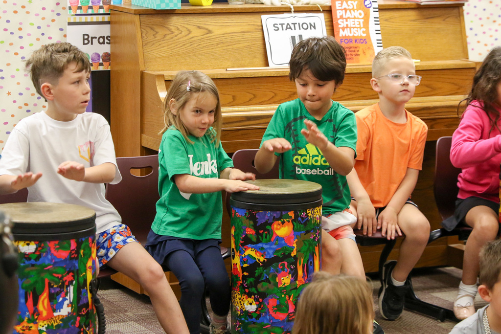 Students playing drums together.