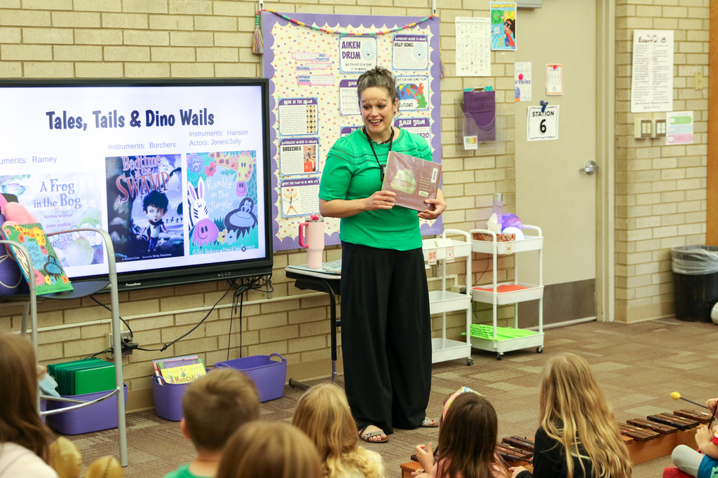 Two students paired together playing the xylophone.