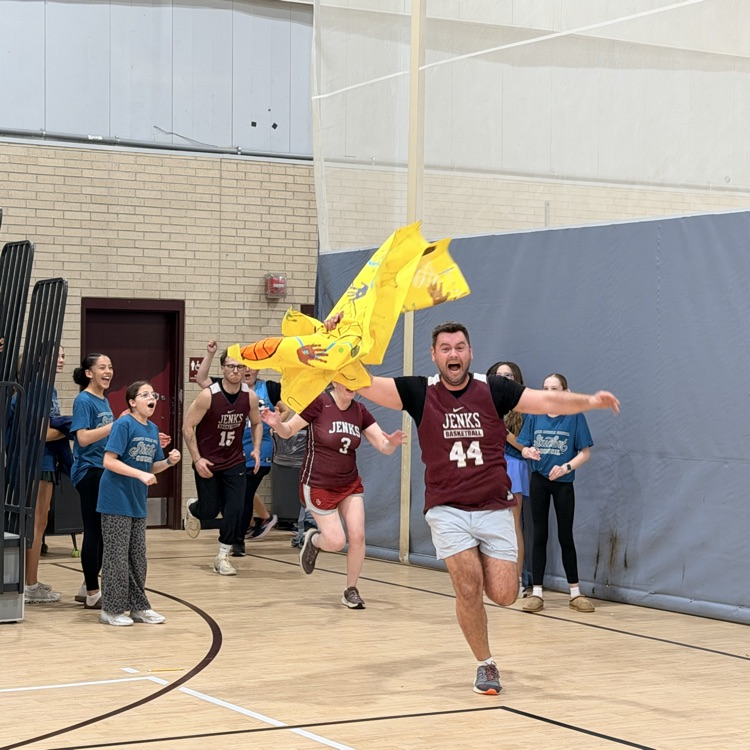 Mr Ratliff running through banner