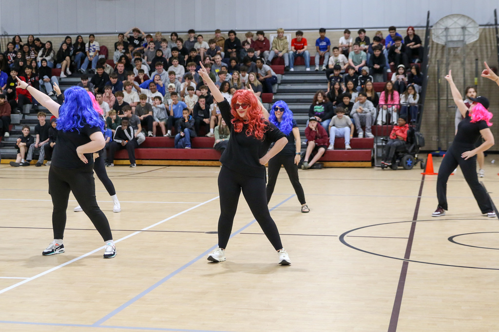 Teachers in wigs performing a dance for the halftime show.