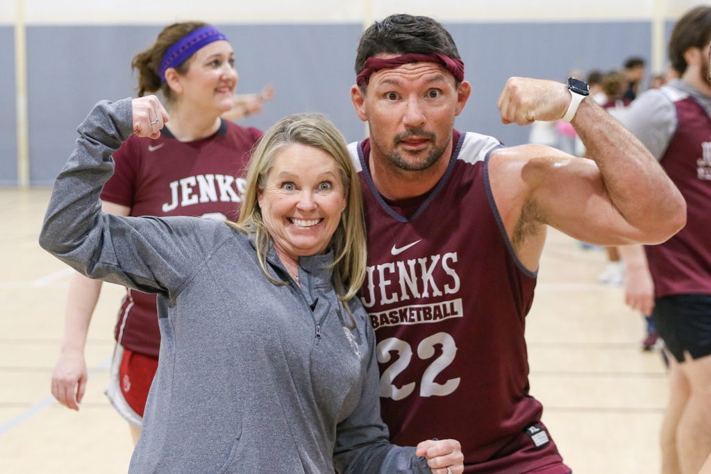 Teacher and Principal posing together for a photo flexing their muscle.