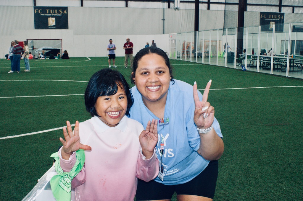JPS staff member with a student smiling for a photo.