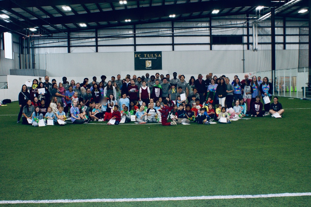Group photo of all students with the FC Tulsa team.