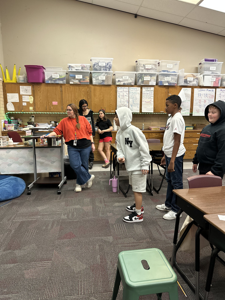 Group of students working together to analyze data from a basketball game to work on math skills.